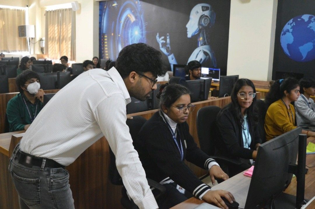 A mentor helping participants work through a computer lab challenge