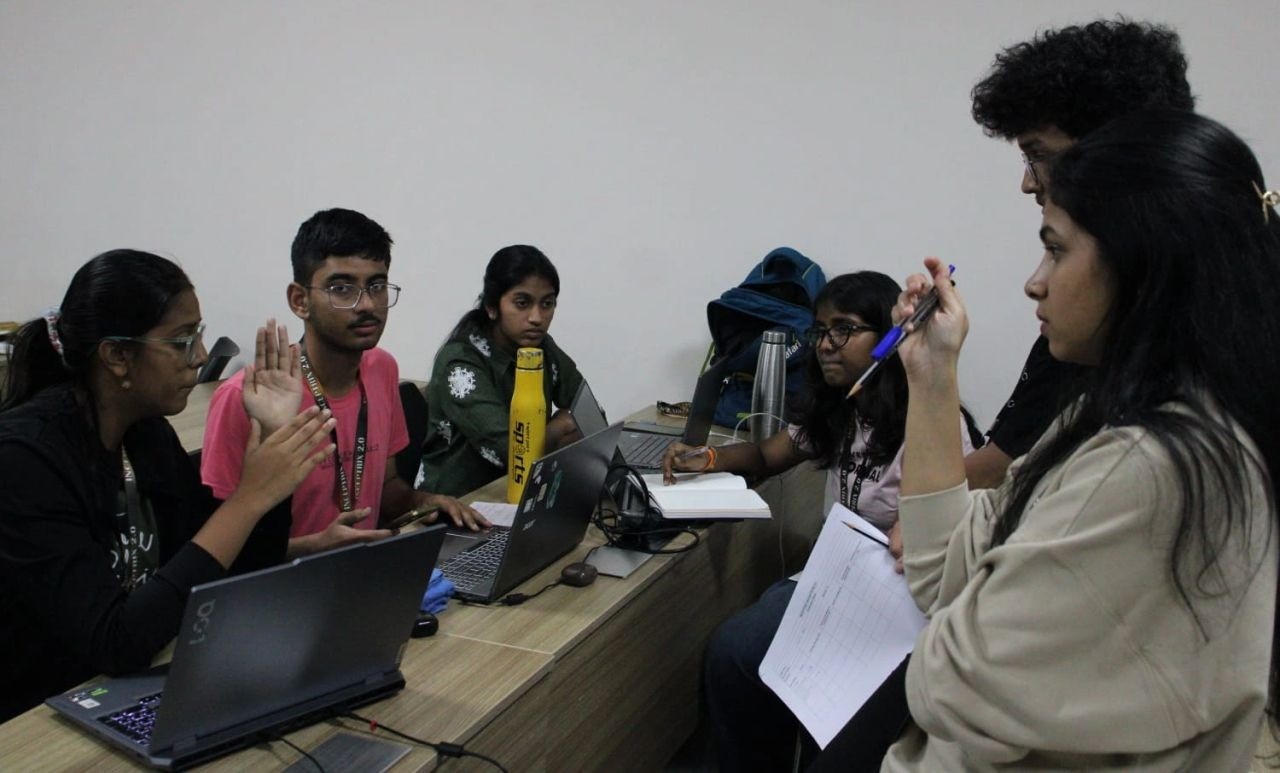 A team discussion around laptops and project materials