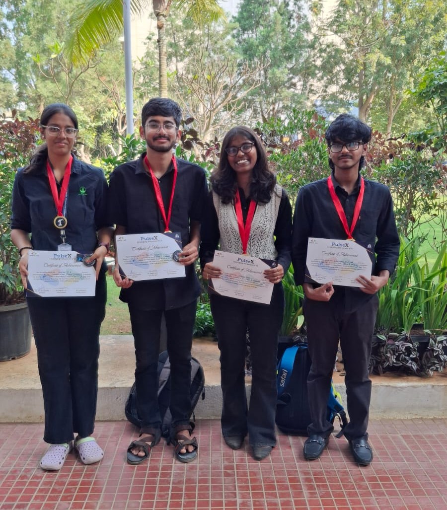 Team members outdoors with their awards
